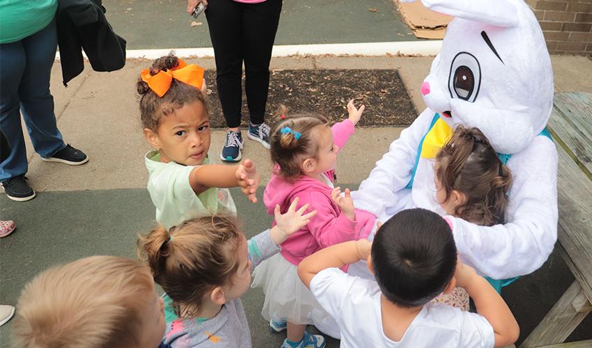 Kids getting ready to hug Mr. Bunny.